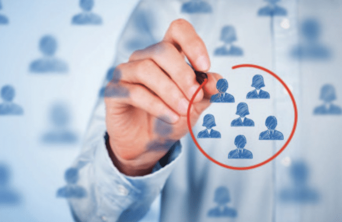 man on whiteboard circling people in red